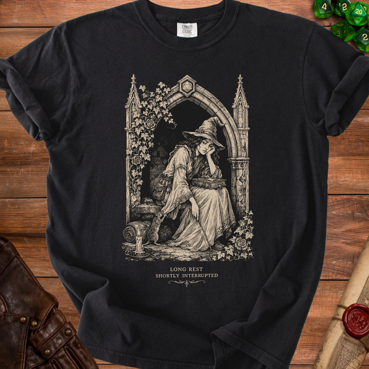 Black t-shirt with vintage illustration of a witch and rat, text "Long Rest Shortly Interrupted".