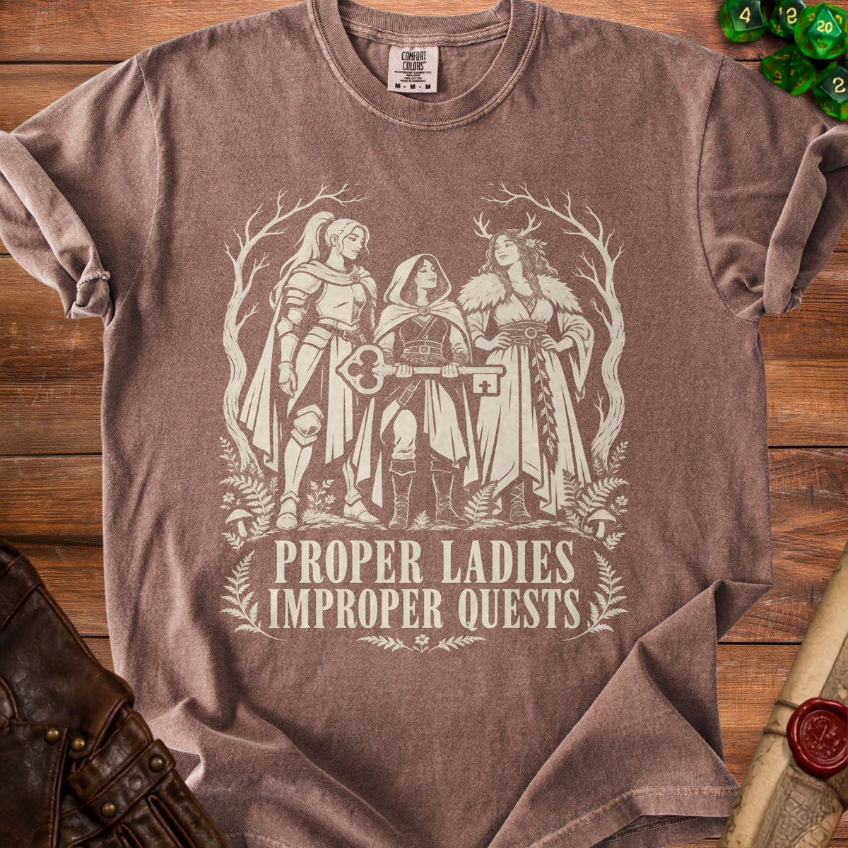 T-shirt with a graphic of three women holding a key, with text "Proper Ladies Improper Quests".