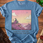 Blue t-shirt with graphic of knight overlooking a peaceful landscape with text "IDGAF IN A GOOD WAY.. IT'S PEACEFUL OVER HERE"