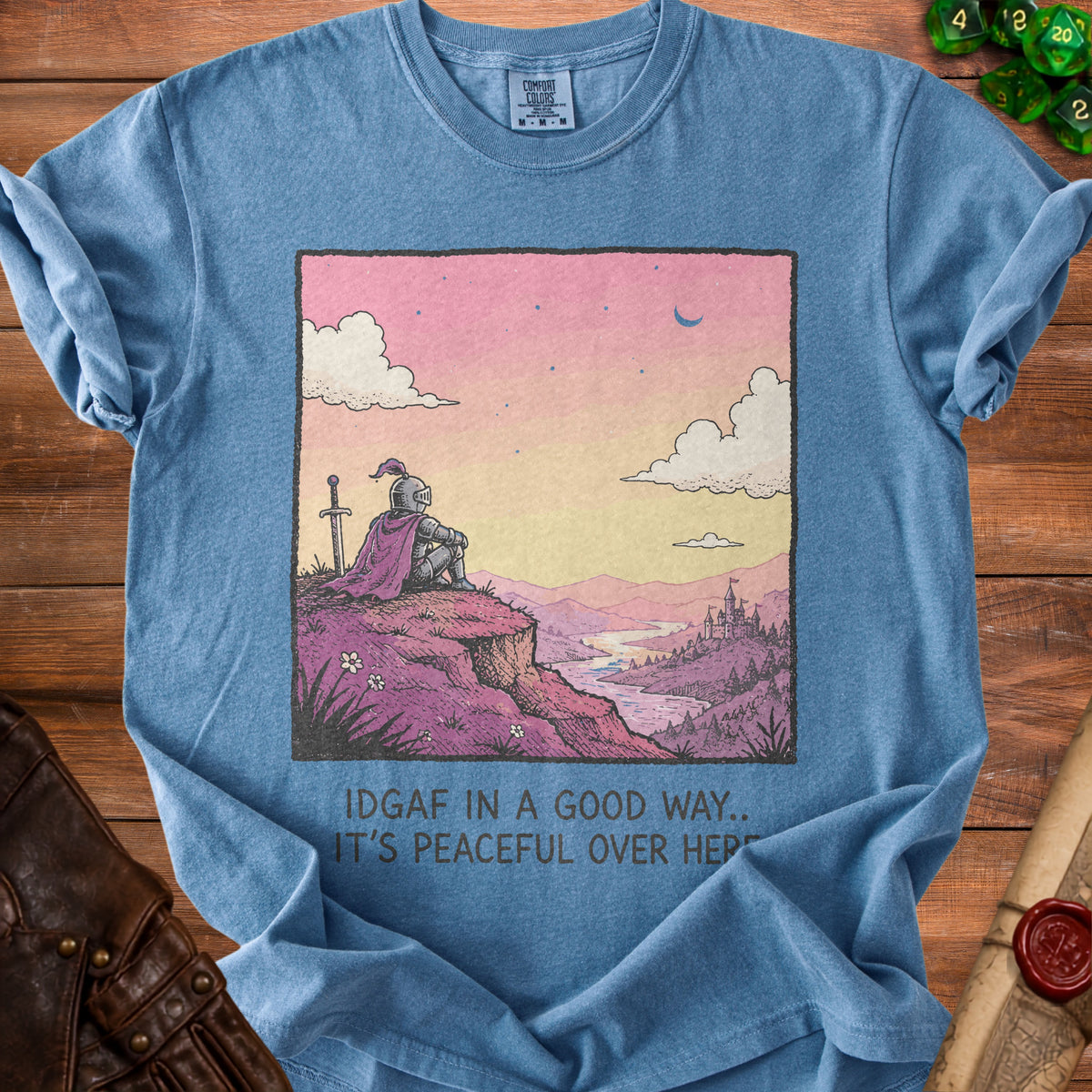 Blue t-shirt with graphic of knight overlooking a peaceful landscape with text "IDGAF IN A GOOD WAY.. IT'S PEACEFUL OVER HERE"