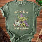Green t-shirt with cartoon goblin, egg, and text "casting first thinking later."