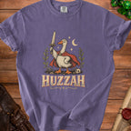 Purple t-shirt with a goose wearing a cape and holding a sword, with text "HUZZAH".