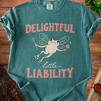 Teal t-shirt with fairy frog graphic and text "DELIGHTFUL little LIABILITY".