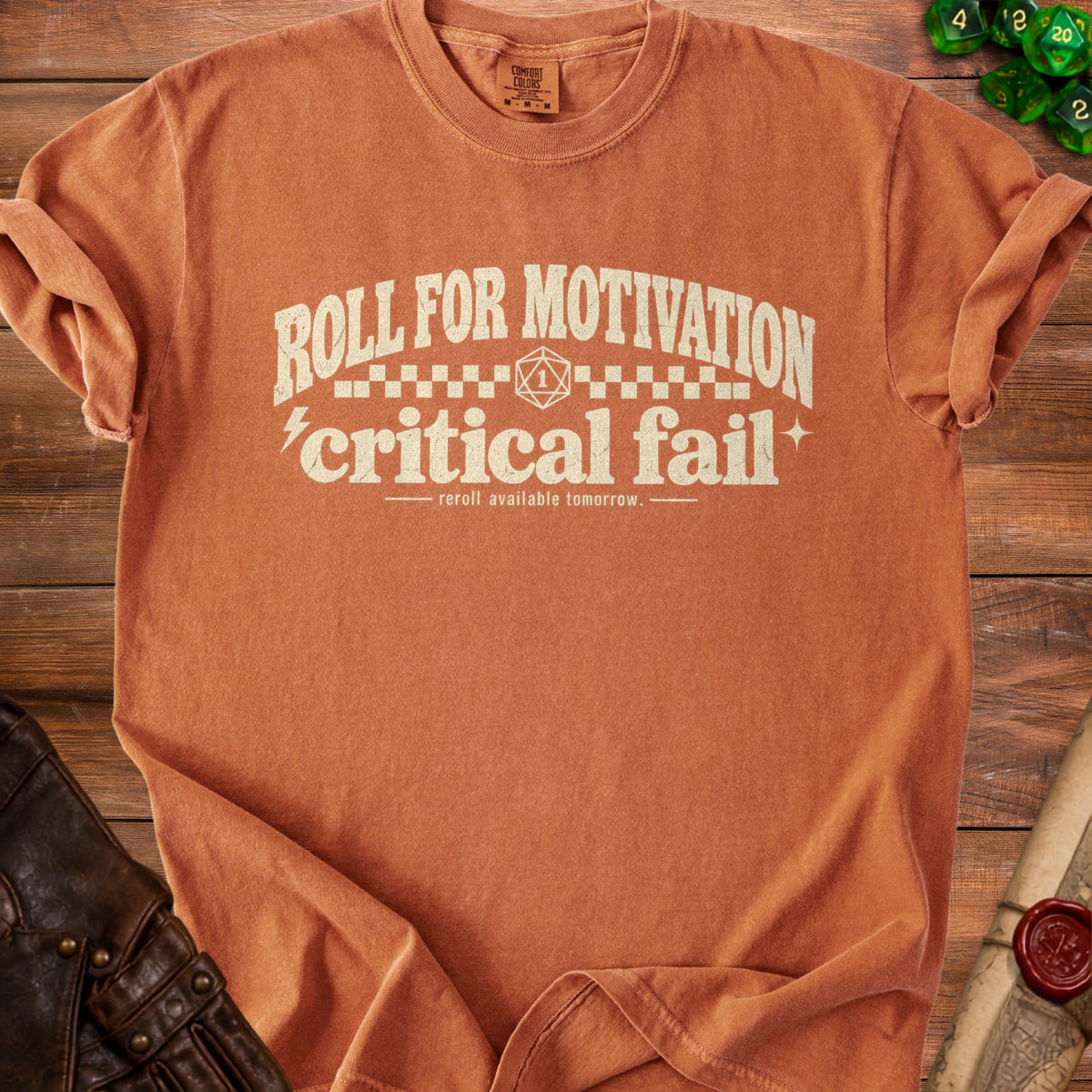 Orange t-shirt with "Roll for Motivation, Critical Fail" text and a d20 die.