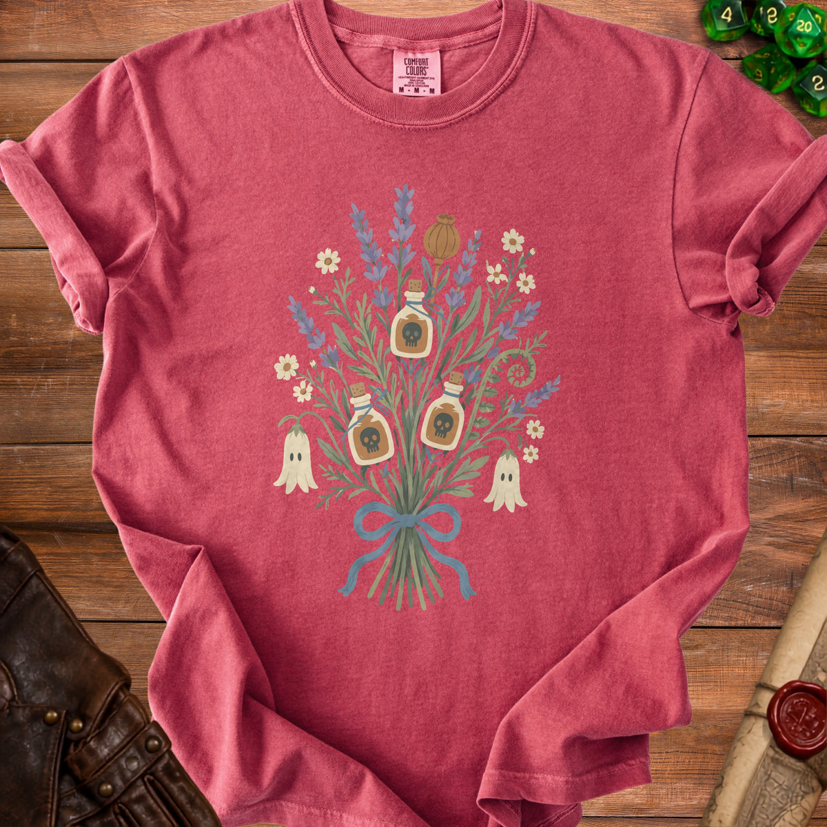 Red t-shirt with floral graphic of potion bottles, ghosts, and poppy pod.