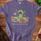 Green creature panics near dice, laptop, pizza, and a sock with text "PANIC IS A FREE ACTION".