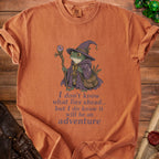 Orange t-shirt with a wizard frog graphic and text: "I don't know what lies ahead... but I do know it will be an adventure."
