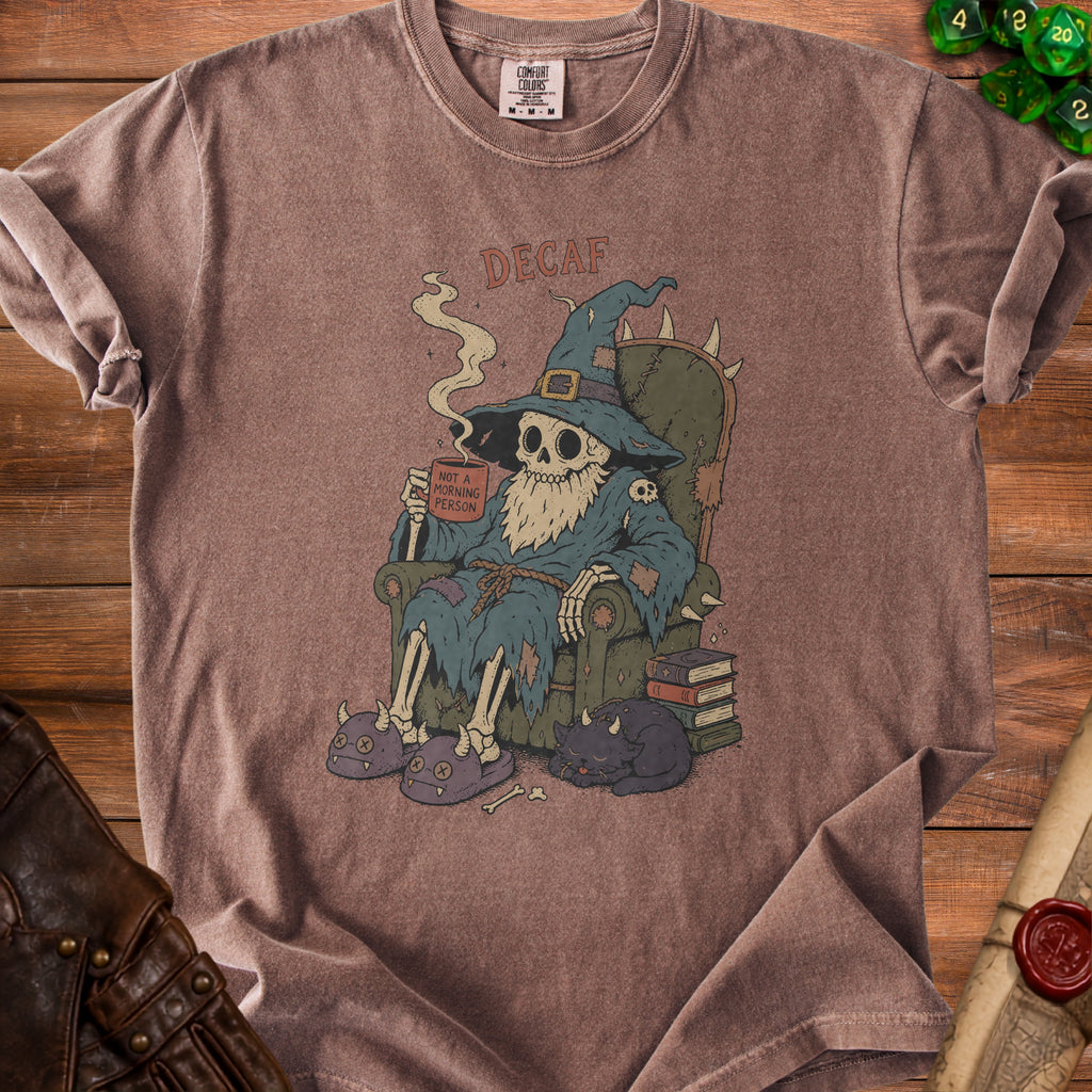 Skeleton wizard wearing slippers and holding a "Not a Morning Person" mug with text "DECAF".