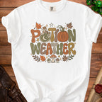 White t-shirt with "Potion Weather" text and fall graphics.