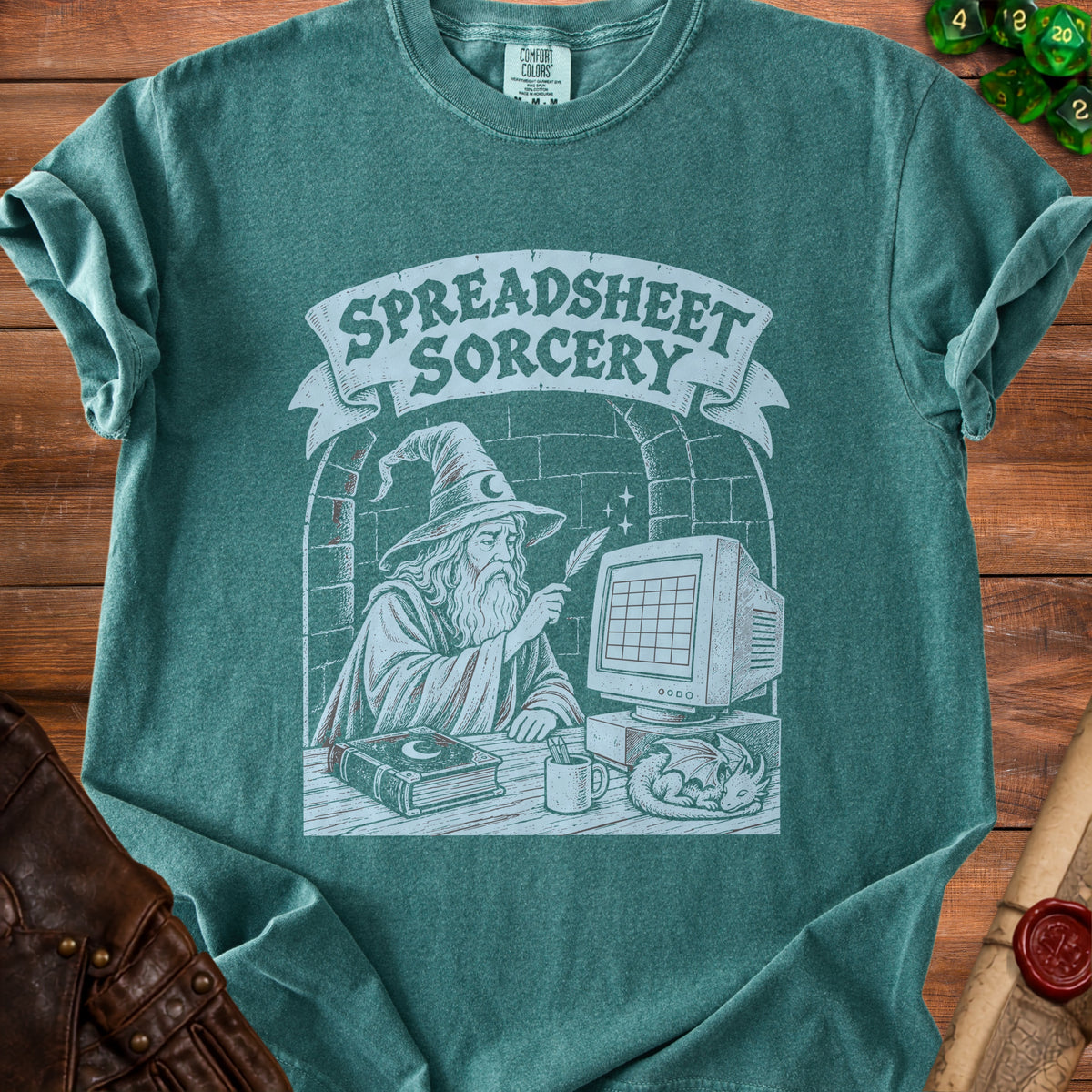 Green t-shirt graphic: wizard using quill on computer with "Spreadsheet Sorcery" banner.