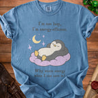Blue t-shirt with penguin graphic and text: "I'm not lazy, I'm energy-efficient. Why waste energy when I can save it?"