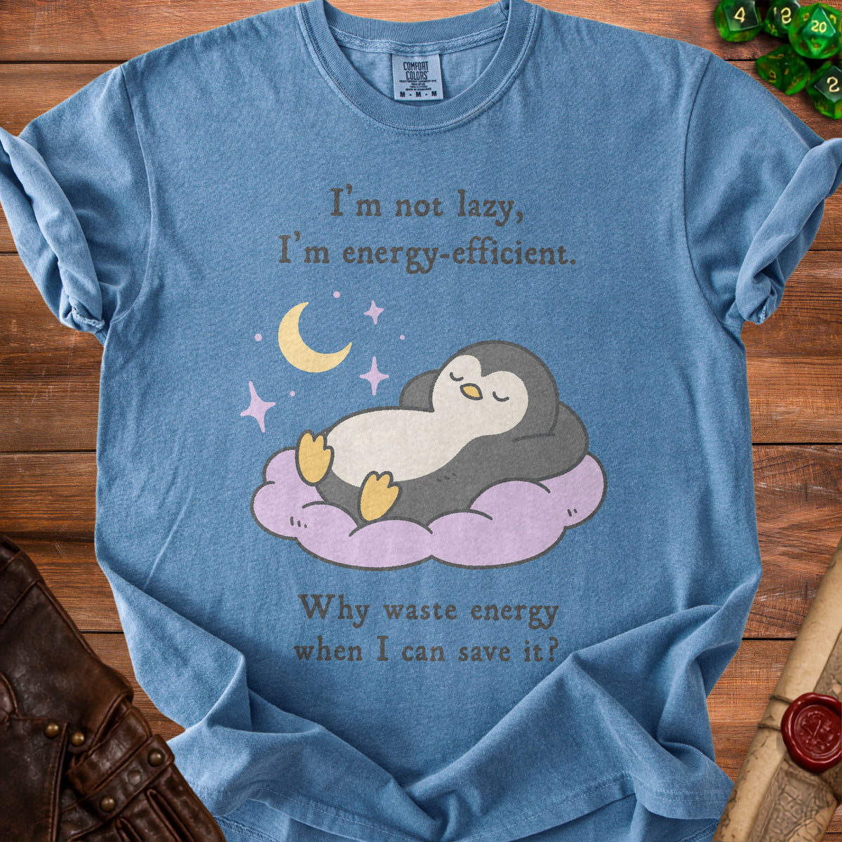 Blue t-shirt with penguin graphic and text: "I'm not lazy, I'm energy-efficient. Why waste energy when I can save it?"