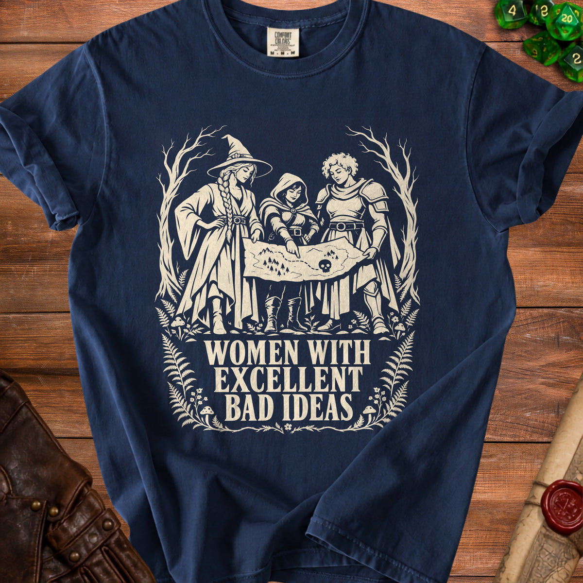 T-shirt with graphic of three women adventurers examining a map, text "WOMEN WITH EXCELLENT BAD IDEAS".