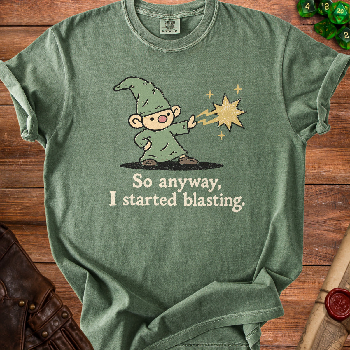 Green t-shirt with cartoon wizard casting a star spell and text "So anyway, I started blasting."
