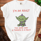White t-shirt with a cartoon goblin and text "I'm an adult the same way a tomato is a fruit."