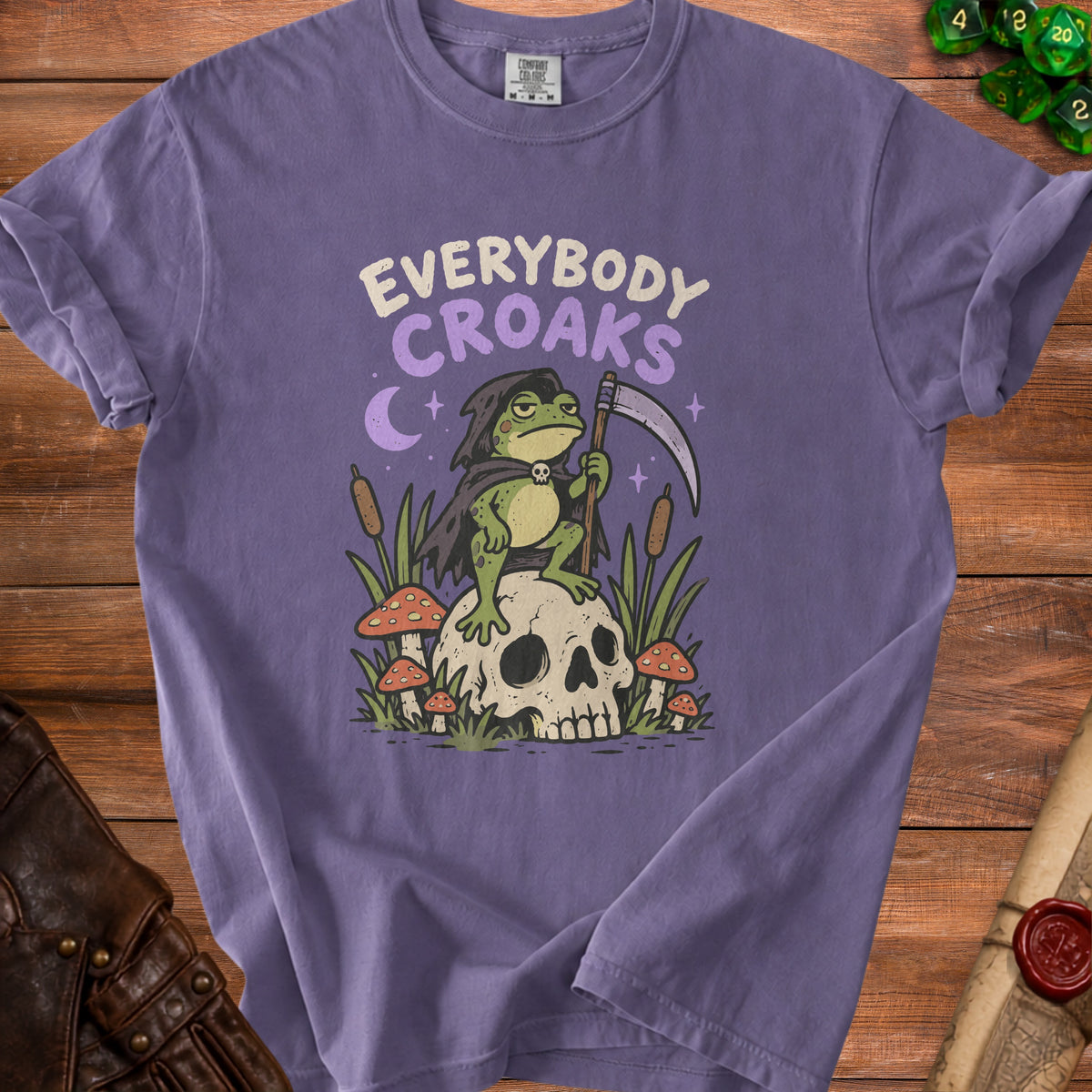 Purple t-shirt with "Everybody Croaks" text and Grim Reaper frog on a skull.