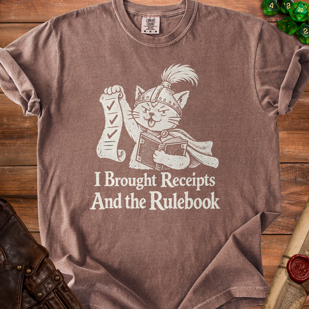 Brown t-shirt with a cat in a helmet holding a checklist and book with text.