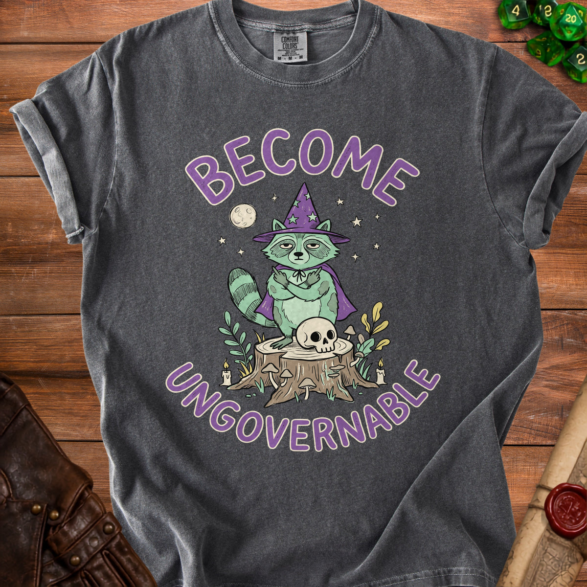 Graphic tee with raccoon in witch hat, skull, and "BECOME UNGOVERNABLE" text.
