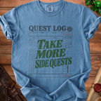 Blue t-shirt with "Quest Log: Take More Side Quests" graphic.