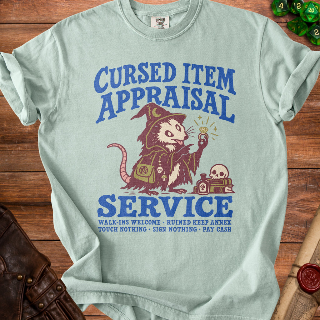 Light blue t-shirt with "Cursed Item Appraisal Service" and possum graphic.
