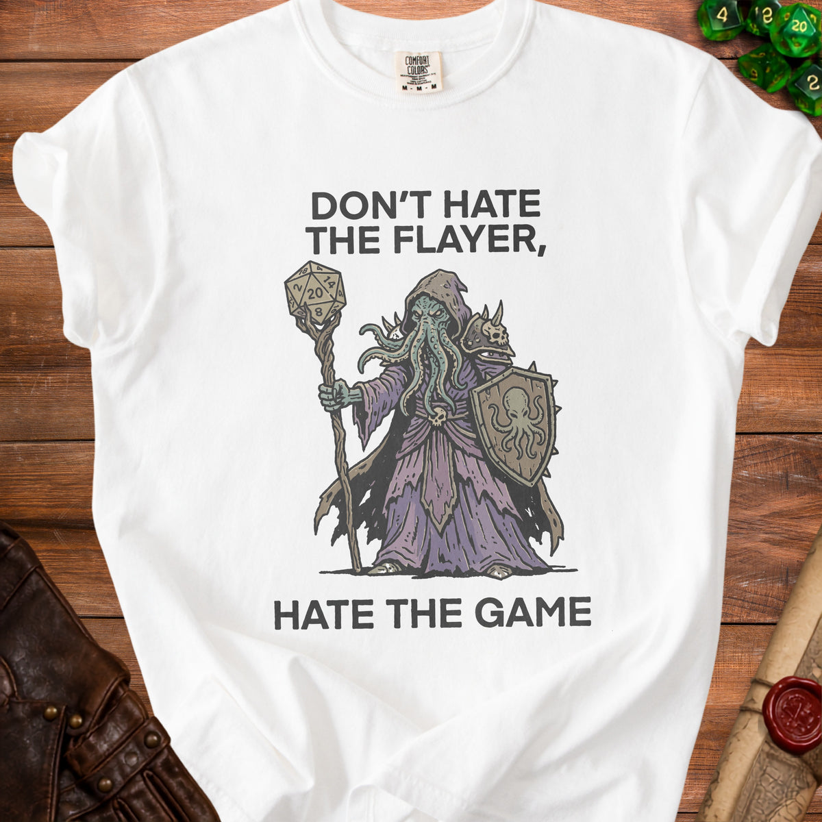 White t-shirt with "Don't hate the flayer, hate the game" text and Cthulhu-like wizard graphic.