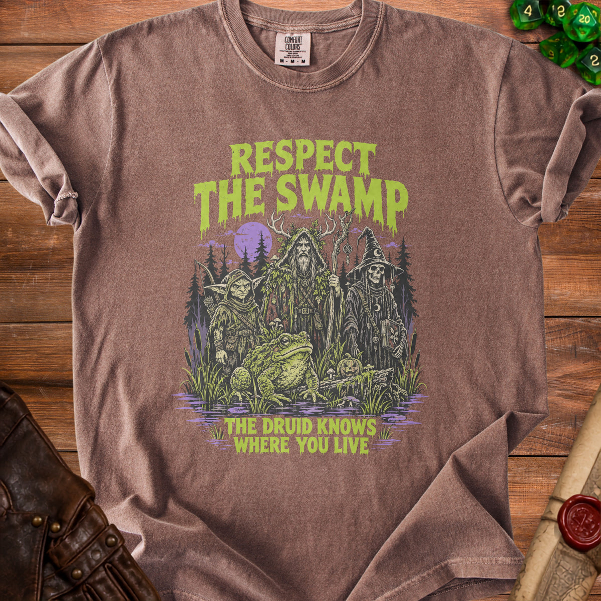 Brown t-shirt with "Respect The Swamp" and "The Druid Knows Where You Live" text.