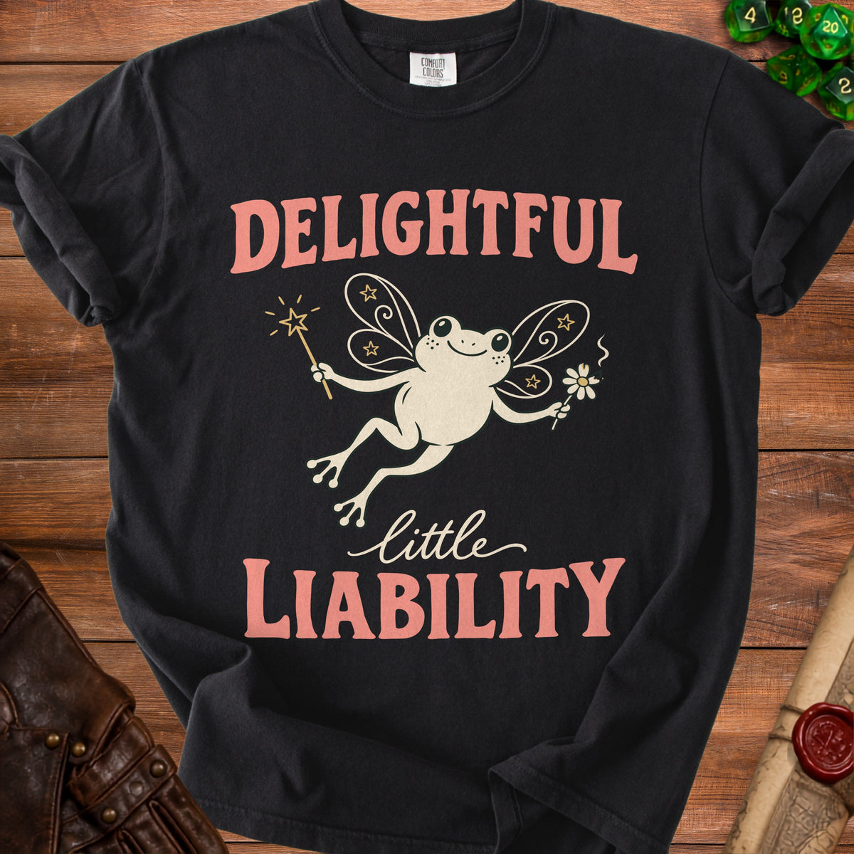 Black t-shirt with fairy frog graphic and text "DELIGHTFUL little LIABILITY".