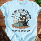 Light blue t-shirt with a black cat typing and the text "TO WHOM IT MAY CONCERN PLEASE SHUT UP".