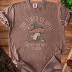 T-shirt with a mushroom wizard graphic and text "Too tired to spell but not too tired to judge".
