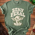 Green t-shirt with "STAY FERAL" text and a mischievous creature graphic.