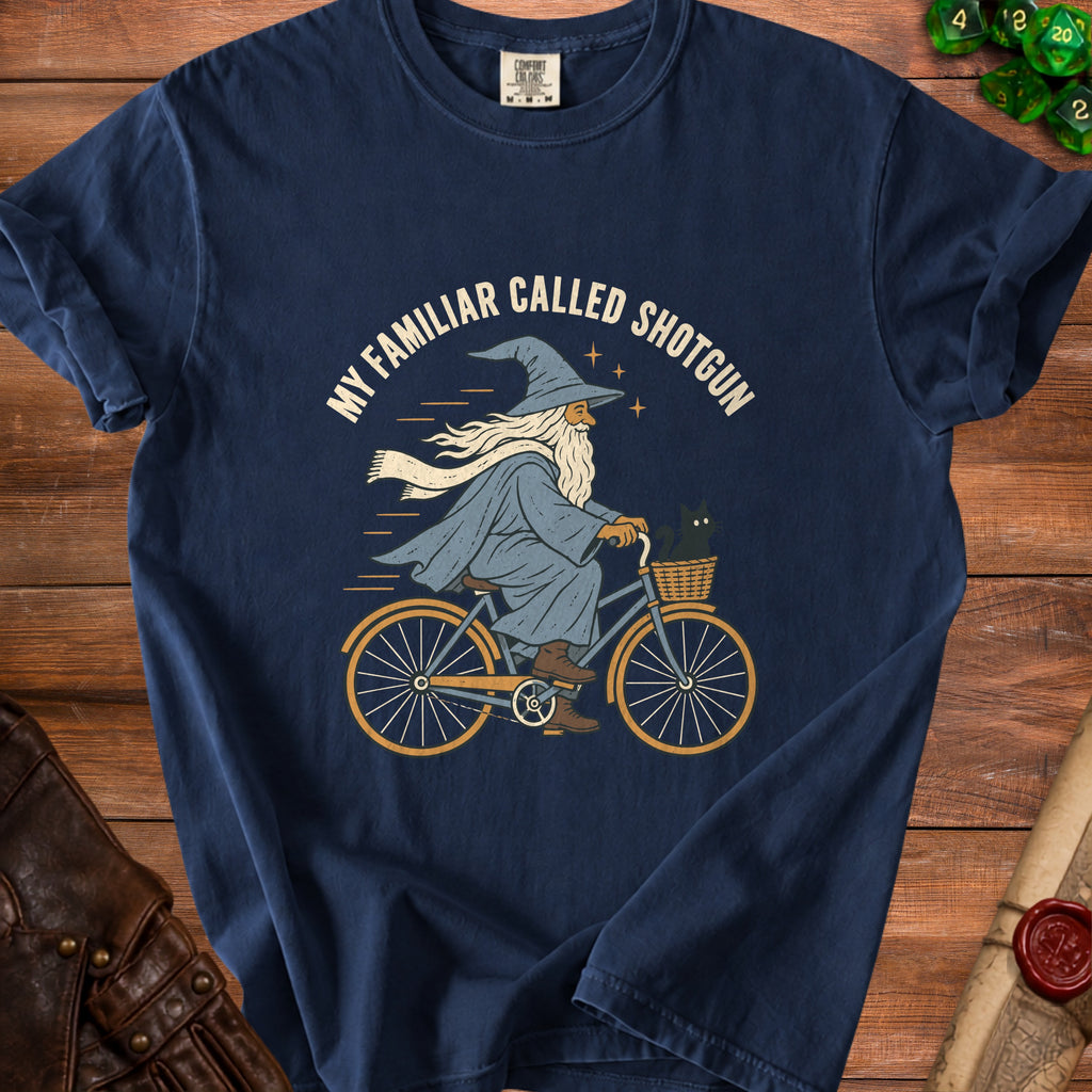 Wizard with beard on bicycle, holding a black cat, with text "My Familiar Called Shotgun".