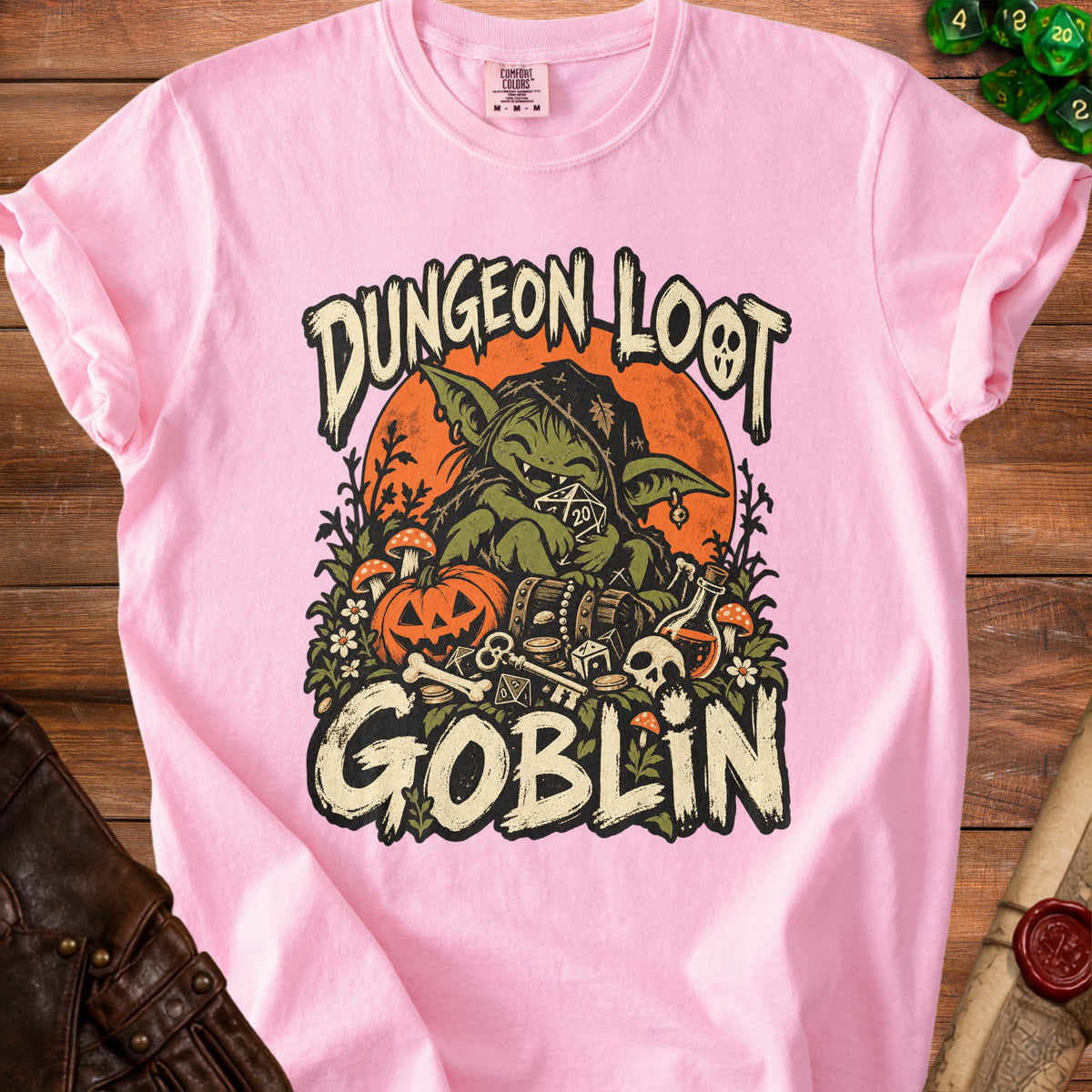 Pink t-shirt with "Dungeon Loot Goblin" graphic featuring a goblin, dice, and treasure.