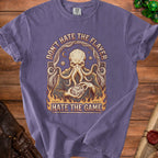 Purple t-shirt graphic with an octopus holding a twenty-sided die, text "Don't Hate the Flayer, Hate the Game."