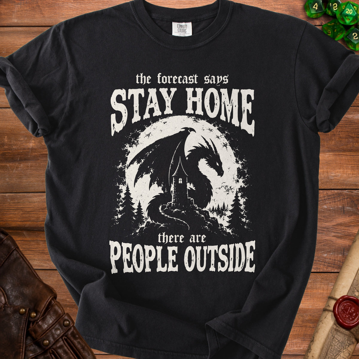 Black t-shirt with dragon, castle, and text "the forecast says STAY HOME there are PEOPLE OUTSIDE".