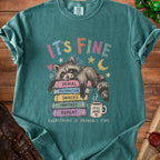 T-shirt with raccoon on books, "It's Fine" and "Everything Is Probably Fine" text.