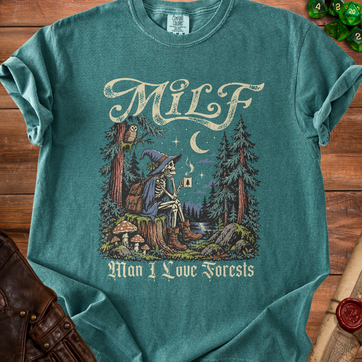 Skeleton in witch hat with coffee in forest scene, text "MILF Man I Love Forests".