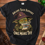 Green creature in wizard hat holds tech device with text "ARCANE TECH SUPPORT" and "ONE MORE TRY".