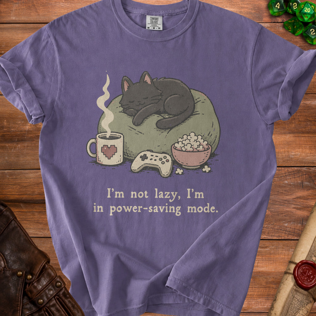 Purple t-shirt with sleeping cat, popcorn, coffee, and controller, stating "I'm not lazy, I'm in power-saving mode."