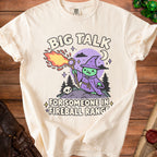 Cream t-shirt with cartoon witch casting fireball and text "Big Talk for Someone in Fireball Range."