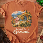 Goblin watering plants outside a hobbit hole with "Gone to Ground" text.