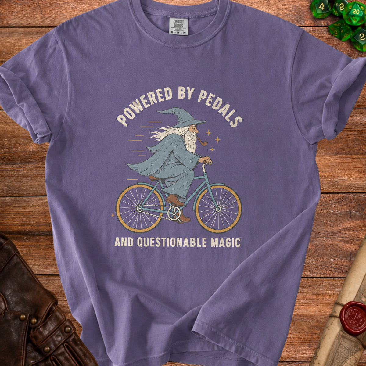 Purple t-shirt with a wizard riding a bicycle and text.