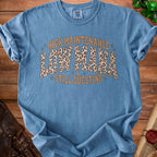 Blue t-shirt with "High Maintenance Low Mana Still Questing" text.