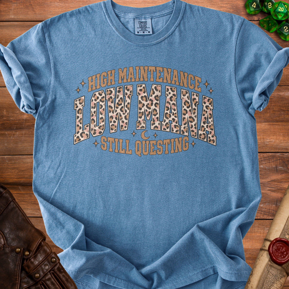 Blue t-shirt with "High Maintenance Low Mana Still Questing" text.