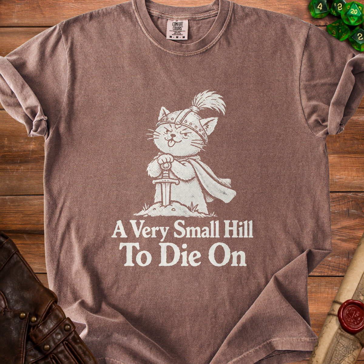 Brown t-shirt with a medieval cat wearing a helmet and holding a sword, reading "A Very Small Hill To Die On".