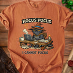 T-shirt with a grumpy cat wearing a witch hat, typing on a laptop, with text "Hocus Pocus I Cannot Focus".