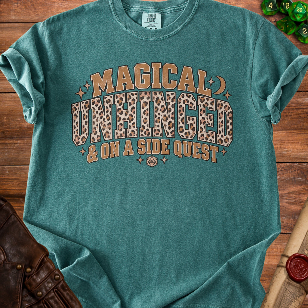 Teal t-shirt with "Magical Unhinged & On A Side Quest" text and leopard print.