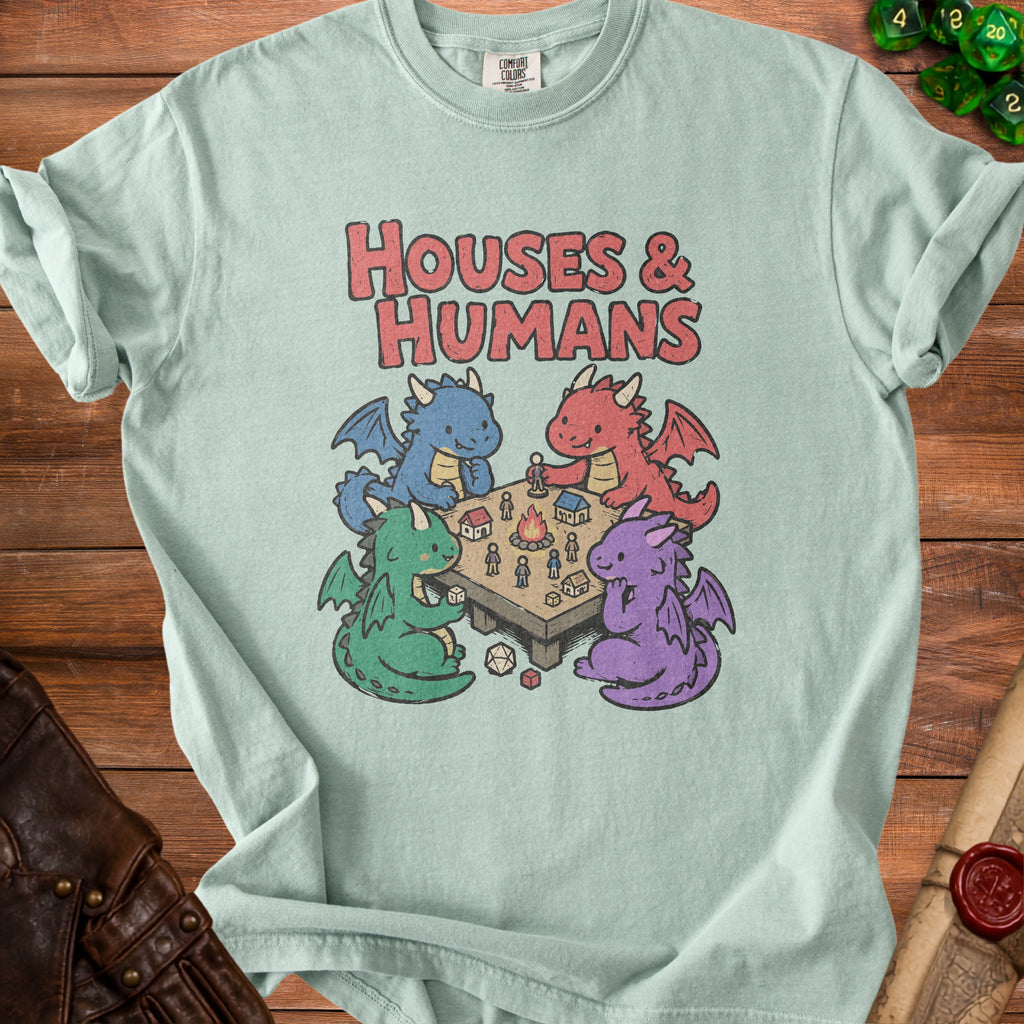 Light blue t-shirt with "Houses & Humans" text and cartoon dragons playing a tabletop game.