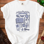 White t-shirt with a blue illustration of occult items and text "Minor curse kit".