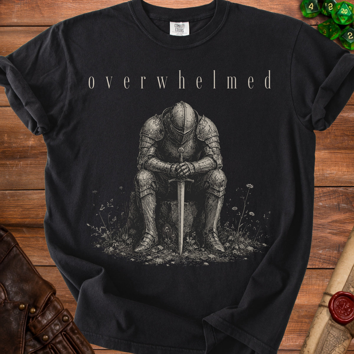 Black t-shirt with "overwhelmed" text above a seated knight holding a sword.