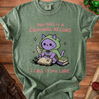 Green t-shirt with a cartoon cat writing "You call it a criminal record, I call it my lore."